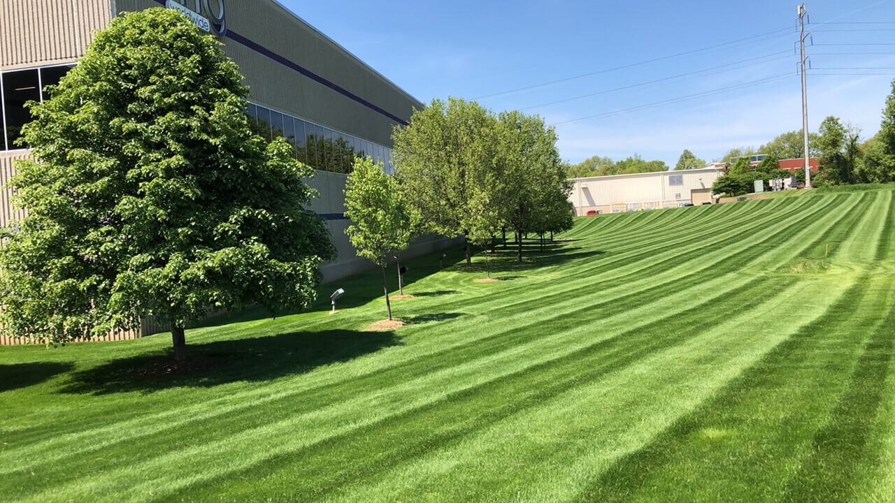Striped grounds beside an industrial building